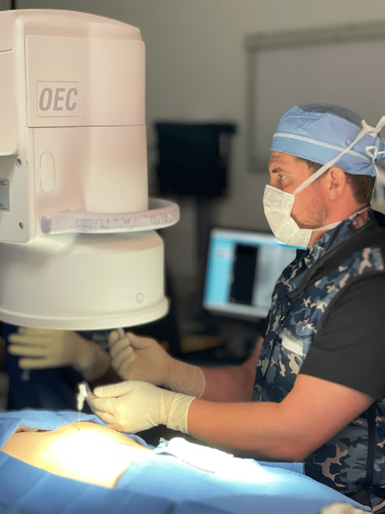 Dr. Peaches performing procedure with C-arm fluoroscopy